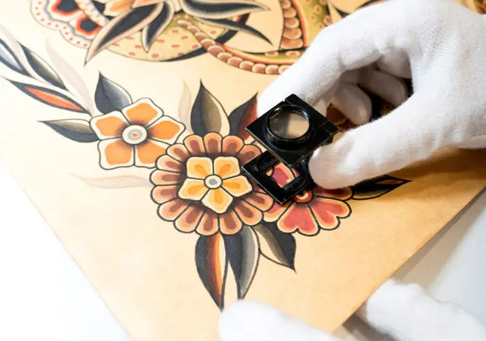 Close up of a magnifying glass on an art piece